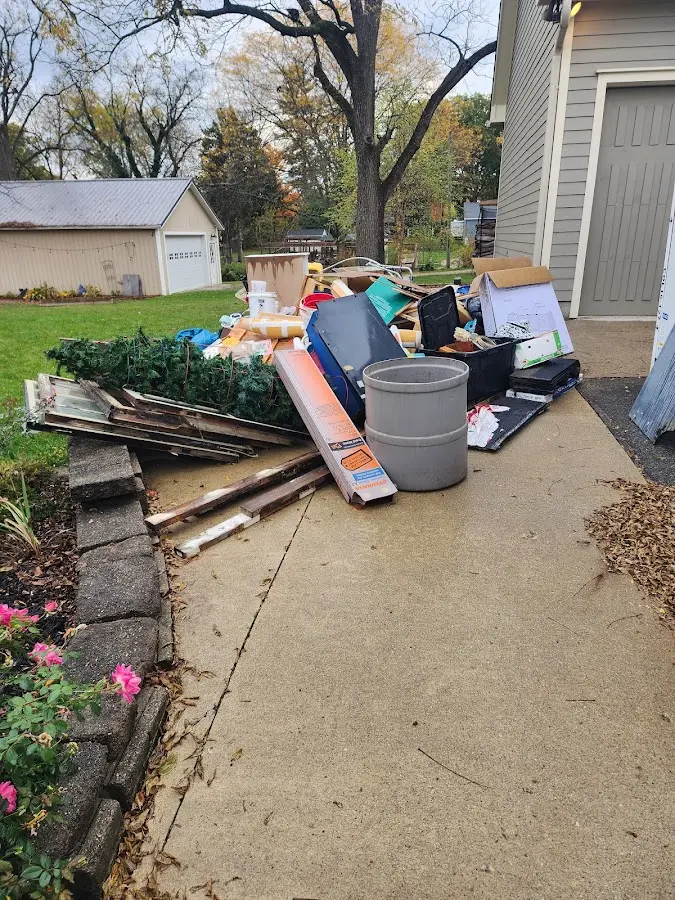 Dumpster being loaded with debris for Roofing Dumpster Rental in Wethersfield